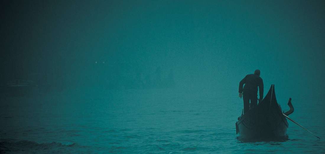A figure at the stern of a gondola in fog