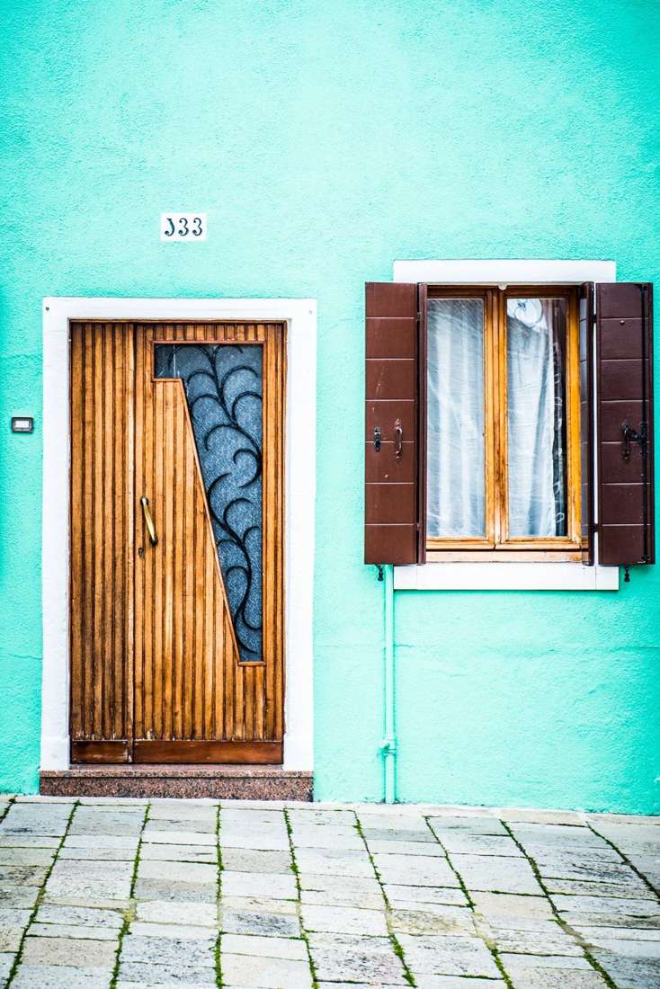 Carved door on a mint wall